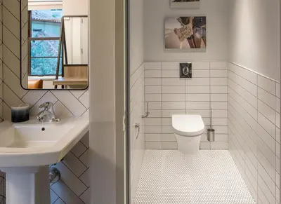 a white bathroom with a sink and a toilet at Generator Miami in Miami Beach