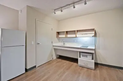 an empty kitchen with a sink and a refrigerator at Extended Stay America Suites - Miami - Airport - Blue Lagoon in Miami