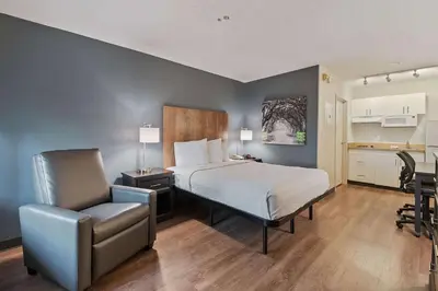 a bedroom with a bed and a desk and a chair at Extended Stay America Suites - Miami - Airport - Blue Lagoon in Miami