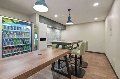 a drink station with a table and chairs and a refrigerator at Extended Stay America Suites - Miami - Airport - Blue Lagoon in Miami