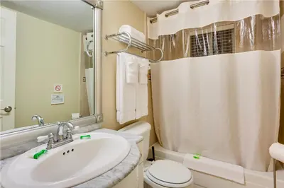 a bathroom with a sink and a toilet and a shower at Sun Harbour Boutique Hotel in Miami Beach