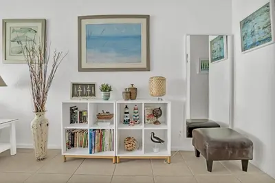 a living room with a white book shelf with books at THE TIDES 2bedrooms apt 14th floor WE ARE ON THE BEACH! in Hollywood