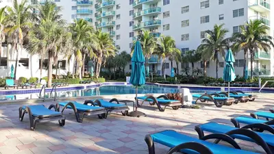 a pool with chairs and umbrellas next to a building at THE TIDES 2bedrooms apt 14th floor WE ARE ON THE BEACH! in Hollywood