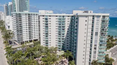 an aerial view of a large white building with palm trees at THE TIDES 2bedrooms apt 14th floor WE ARE ON THE BEACH! in Hollywood