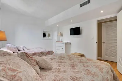 a bedroom with two beds and a tv on the wall at THE TIDES 1bedroom apt 15th floor WE ARE ON THE BEACH! in Hollywood