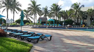 a row of blue benches next to a swimming pool at THE TIDES 1bedroom apt 15th floor WE ARE ON THE BEACH! in Hollywood