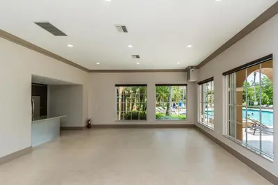 an empty living room with large windows and a pool at Yacht Club at Aventura 1 Bd 1 Bth Brand New in Aventura