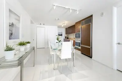 a kitchen and dining room with a table and chairs at Icon Brickell Residences in Miami