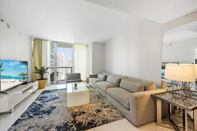 a living room with a couch and a tv at Icon Brickell Residences in Miami