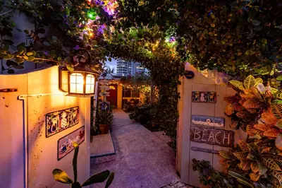 an alleyway with a lamp and plants on a wall at The Desoto - Oceanview Inn in Hollywood
