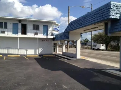 an empty parking lot in front of a gas station at Miami Springs Inn in Miami