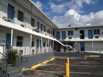 an empty parking lot in front of a building at Miami Springs Inn in Miami
