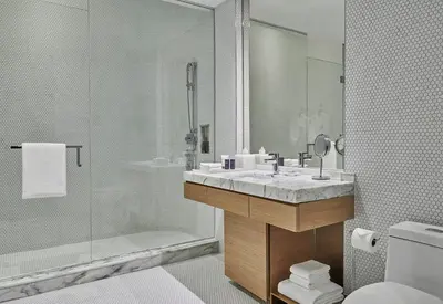 a bathroom with a sink and a shower and a toilet at SLS LUX Brickell in Miami