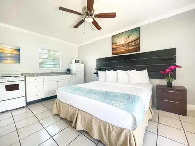 a bedroom with a large bed and a ceiling fan at Ocean Villas in Hollywood