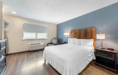 a hotel room with a bed and a chair at Extended Stay America Premier Suites - Miami - Airport - Doral - 87th Avenue South in Miami
