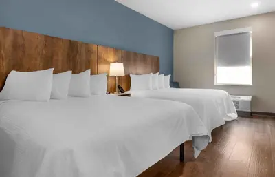 a bedroom with two large white beds and a window at Extended Stay America Premier Suites - Miami - Airport - Doral - 87th Avenue South in Miami