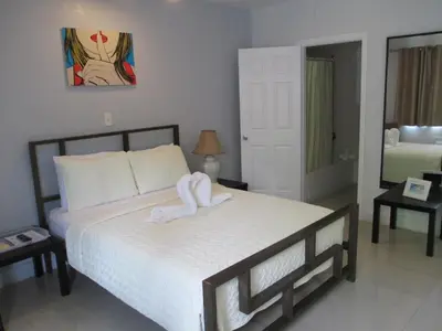 a bedroom with a bed with a towel on it at Shalimar Motel in Miami