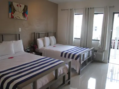 a hotel room with two beds and a balcony at Shalimar Motel in Miami