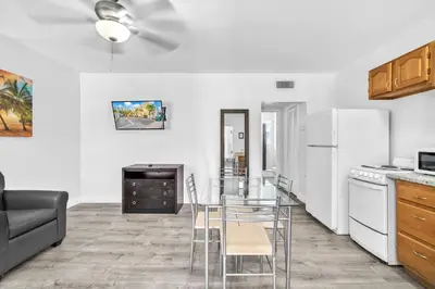 a kitchen with a table and chairs in a room at Laguna Blu Beach in Hollywood