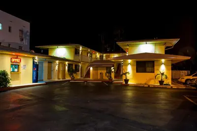 a parking lot in front of a building at night at King Motel - Miami in Miami