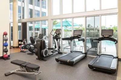 a gym with treadmills and ellipticals in a building at DoubleTree by Hilton Miami Doral in Miami