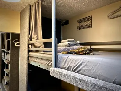 a bunk bed in a room with towels on it at Sheridan Hostel in Dania Beach