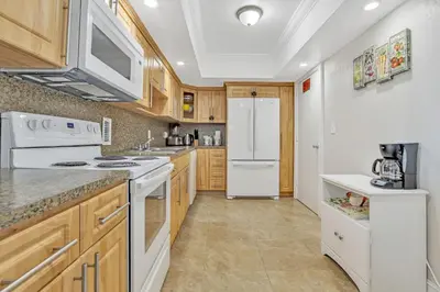 a kitchen with white appliances and wooden cabinets at THE TIDES 1 bedroom apt 10 floor WE ARE ON THE BEACH! in Hollywood