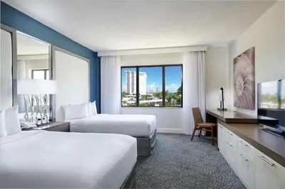 a hotel room with two beds and a large window at Bahia Mar Fort Lauderdale Beach - DoubleTree by Hilton in Fort Lauderdale