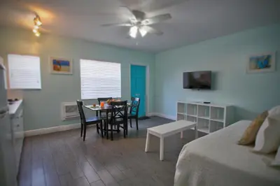 a bedroom with a bed and a table and chairs at Hollywood Beachside Boutique Suite in Hollywood
