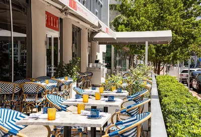 a row of tables and chairs at a restaurant at Hotel Continental Miami Beach, Tapestry Collection by Hilton in Miami Beach