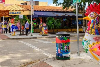a large chickenorical trash can on the side of a street at Migue´s Tiny Miami Alcove in Miami