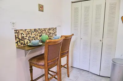 a table with two chairs and a table with a plate on it at The Marlin Rooster Apartments in Miami