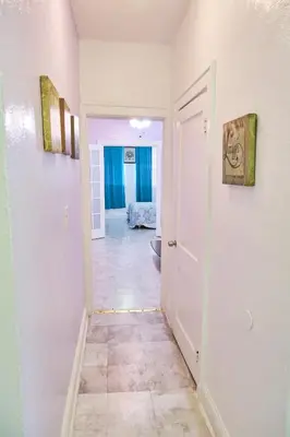 a hallway with a door leading into a room at The Marlin Rooster Apartments in Miami