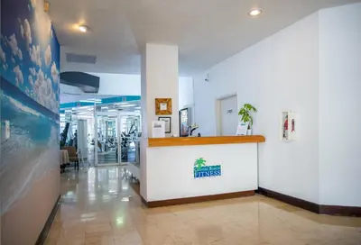 a restaurant lobby with a counter in the middle at Crystal Beach Suites Miami Oceanfront Hotel in Miami Beach