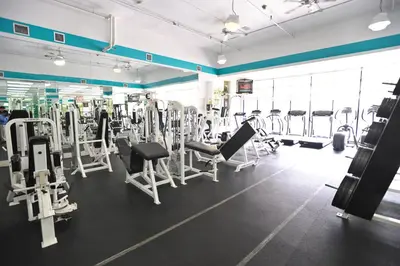 a gym with several rows of tread machines at Crystal Beach Suites Miami Oceanfront Hotel in Miami Beach