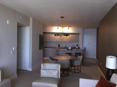 a living room with a table and chairs and a kitchen at Rent in LYFE Resort in Hollywood