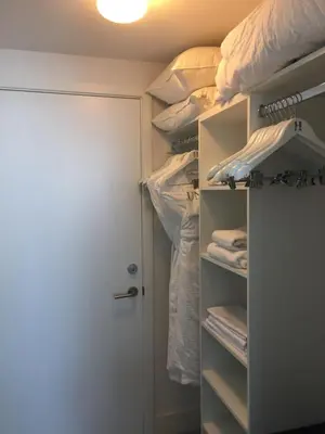 a room with a closet with a bed and towels at Rent in LYFE Resort in Hollywood