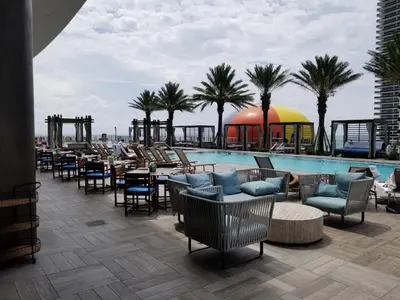 a resort with a pool and tables and chairs at Rent in LYFE Resort in Hollywood