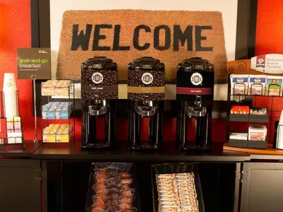 a store with a welcome sign on a counter at Extended Stay America Premier Suites - Miami - Airport - Miami Springs in Miami
