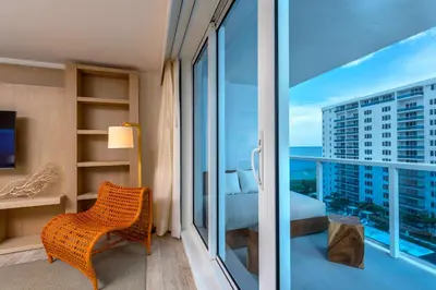 a room with a balcony with a view of a bedroom at Oceanview Private Condo at 1 Hotel & Homes -906 in Miami Beach