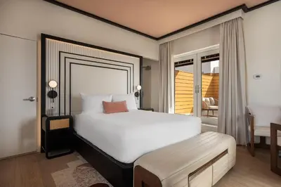 a bedroom with a large bed and a balcony at Eurostars Winter Haven Miami Beach in Miami Beach
