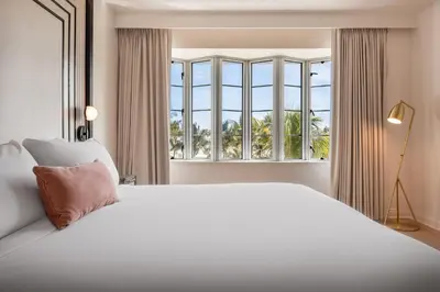 a bedroom with a large bed and a large window at Eurostars Winter Haven Miami Beach in Miami Beach