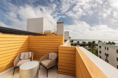 a balcony with two chairs and a table on a building at Eurostars Winter Haven Miami Beach in Miami Beach