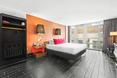 a hotel room with a bed and a fireplace at The Fairwind Hotel in Miami Beach