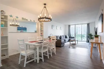 a dining room and living room with a table and chairs at Ocean Reserve Condominium in Miami Beach