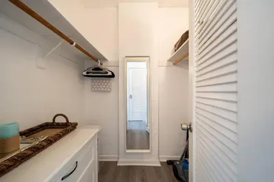 a kitchen with white walls and a sink and a window at Ocean Reserve Condominium in Miami Beach