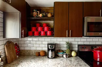 a kitchen with a coffee maker on a counter at The Captain's Quarters - Home & Guesthouse in Fort Lauderdale