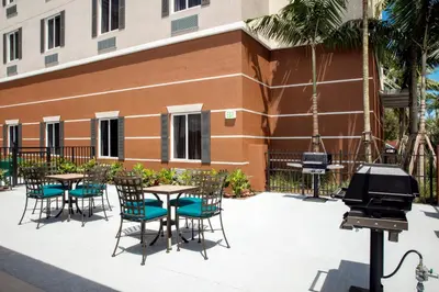 a patio with tables and chairs and a piano at Candlewood Suites - Miami Exec Airport - Kendall by IHG in Kendall