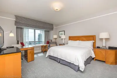 a bedroom with a bed and a desk and a television at Signature Suite at Four Seasons Residences - Limited Time Offer in Miami