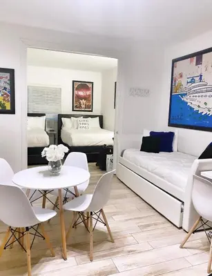 a living room with a bed and a table and chairs at 2 Bedroom Ocean Drive Newly Renovated in Miami Beach